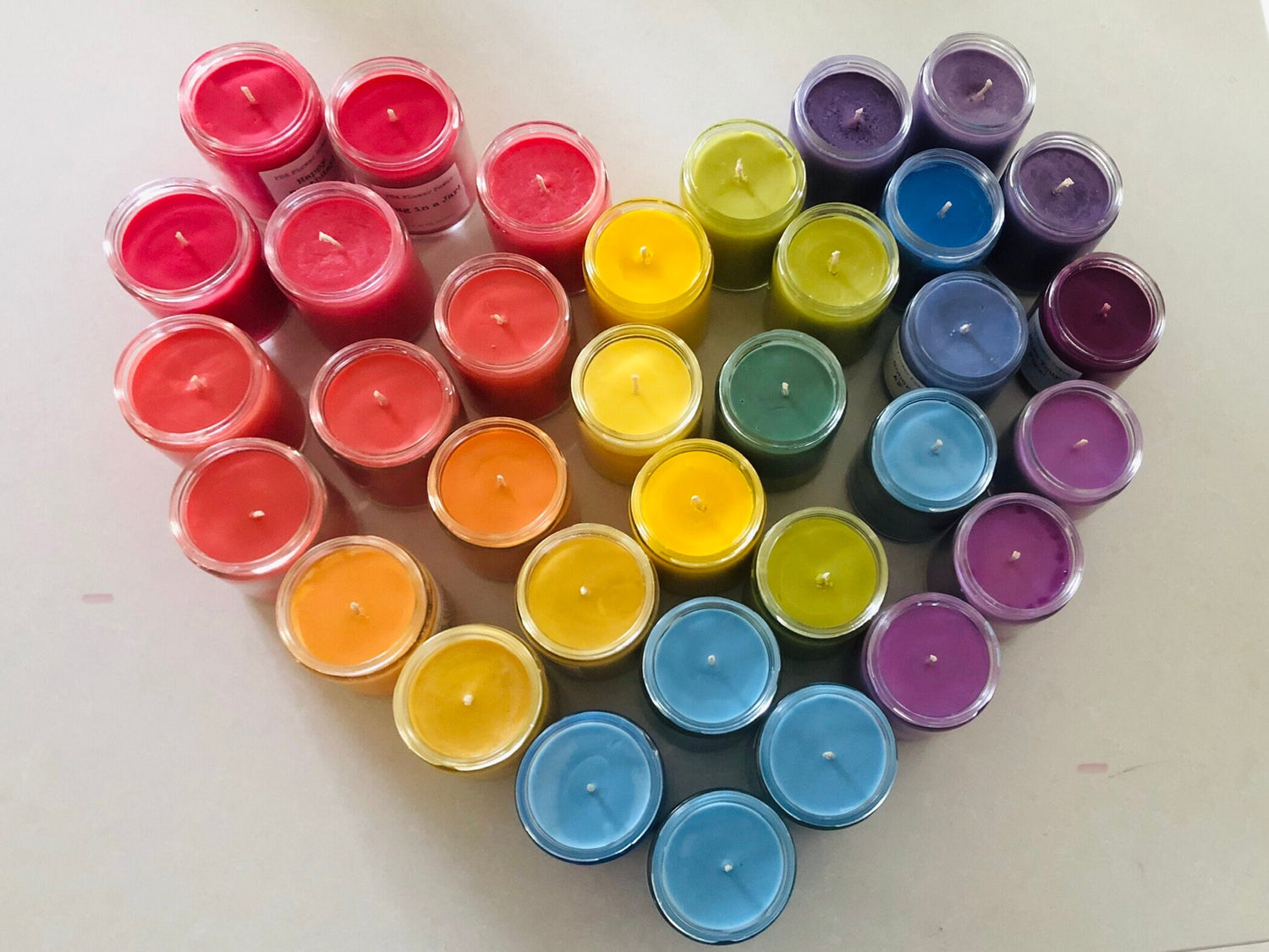 soy candles, handcrafted soy candles, Rainbow of soy candles colors grouped in a heart, rainbow heart made of candles